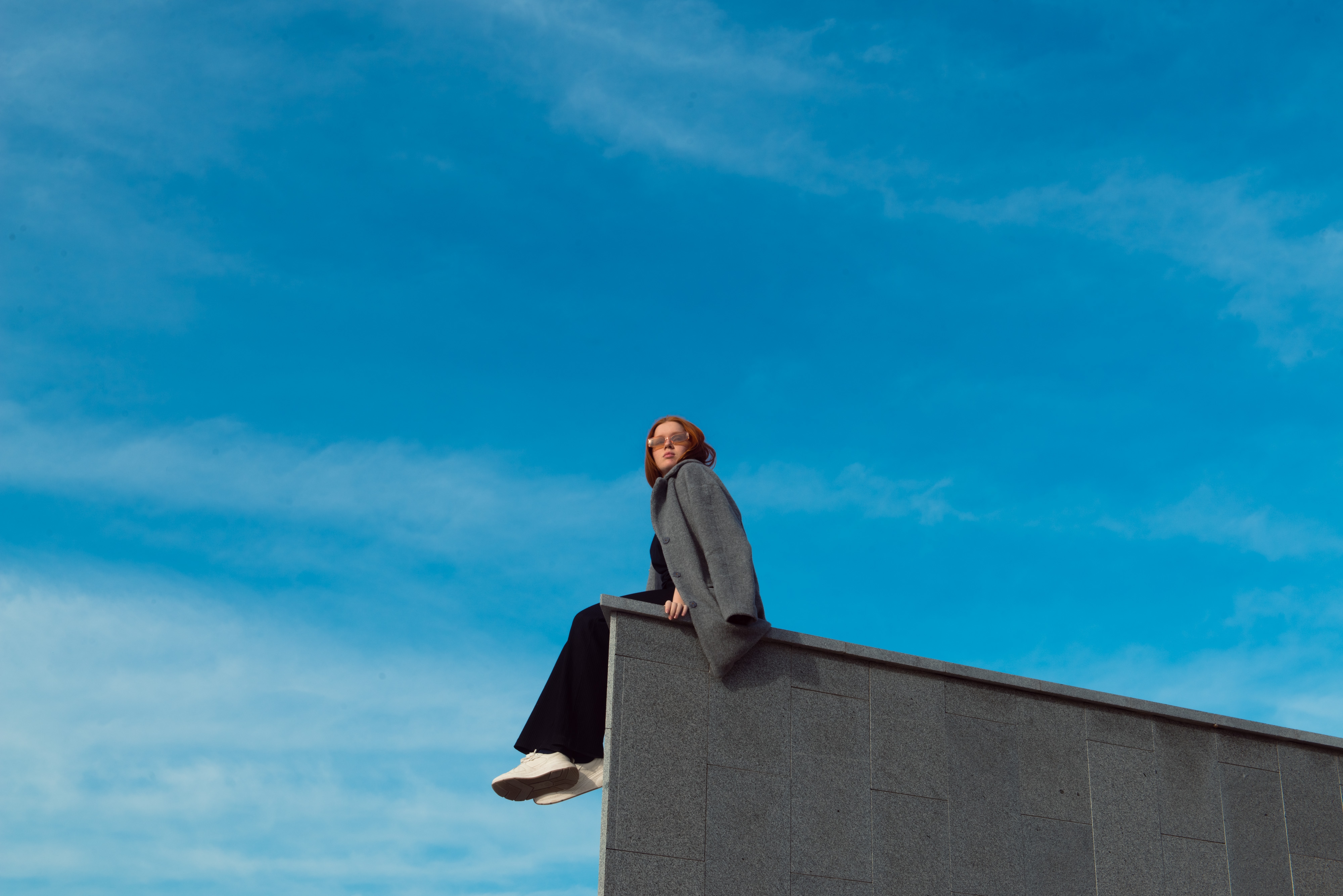 Red Headed girl on a city wall